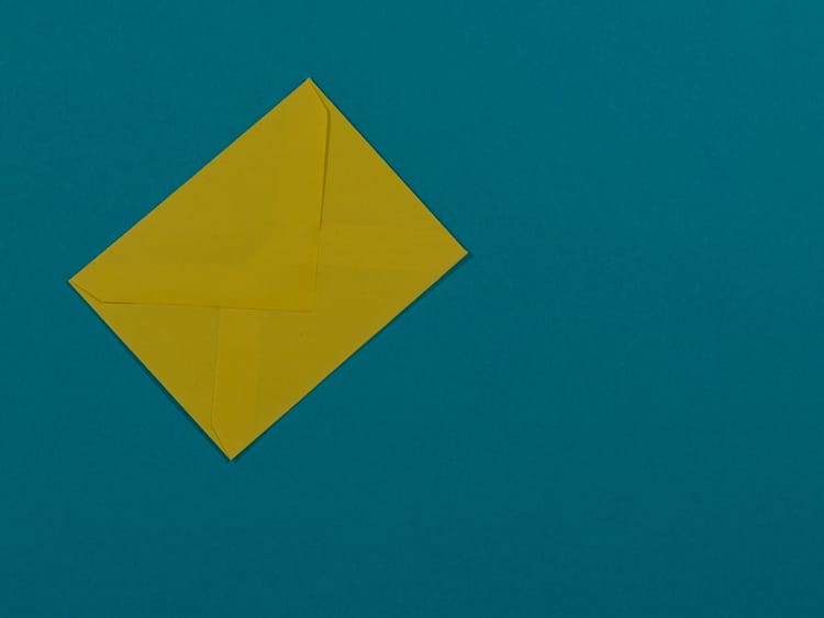 A yellow paper envelope on a blue background